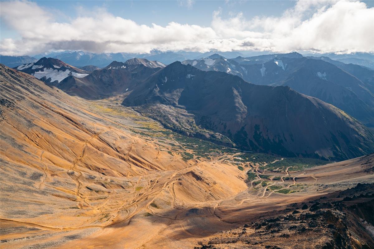 A mountain range with snow and clouds  AI-generated content may be incorrect.