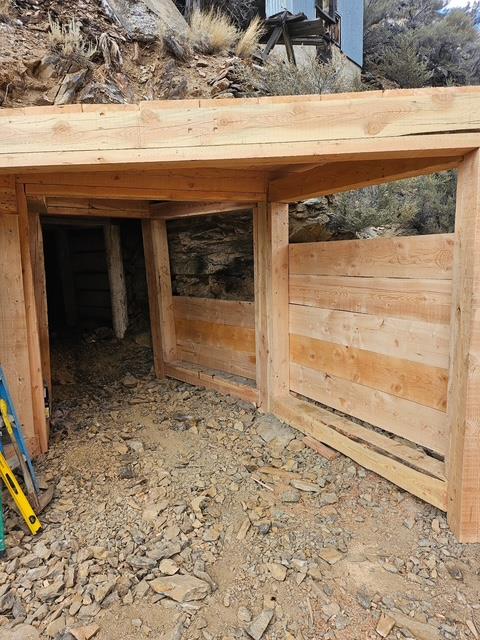 A wooden structure with a door open  AI-generated content may be incorrect.